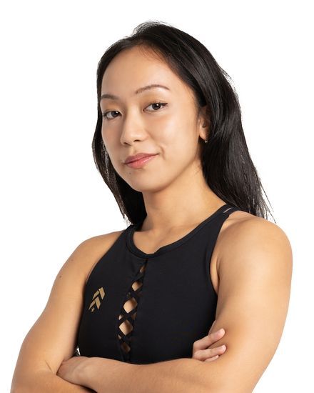 Mandalyn Tan in black training kit, arms crossed, smiling slightly at the camera